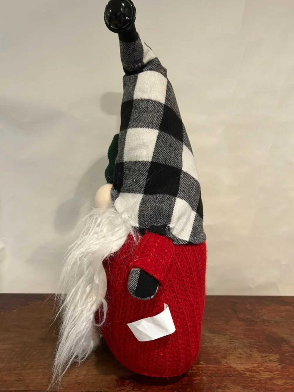 Christmas Holiday Gnome with bean bag base and bell on cap holding a tree